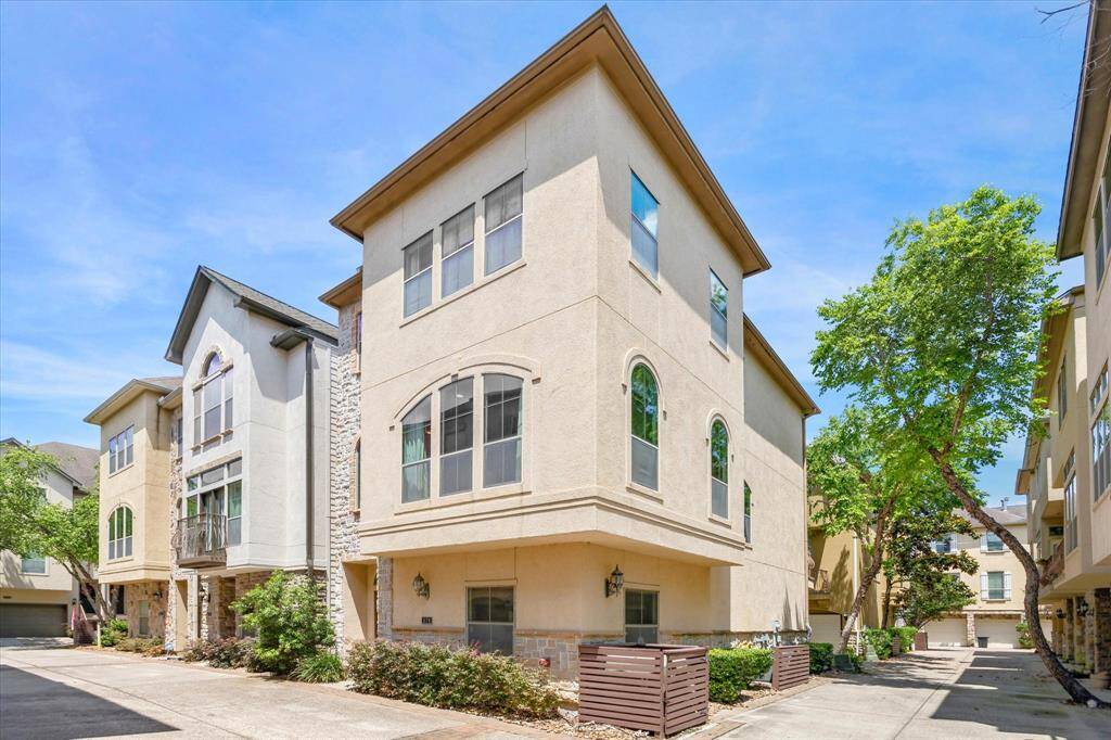 Framed by mature trees and nestled at the end of a quiet, gated drive, this sun-drenched corner unit at 574 Bomar offers privacy and presence. Stucco and stone accents complement the soft arches and architectural lines, setting the tone for the refined interiors within. Ample windows wrap the home in natural light while tasteful landscaping adds to the inviting curb appeal.