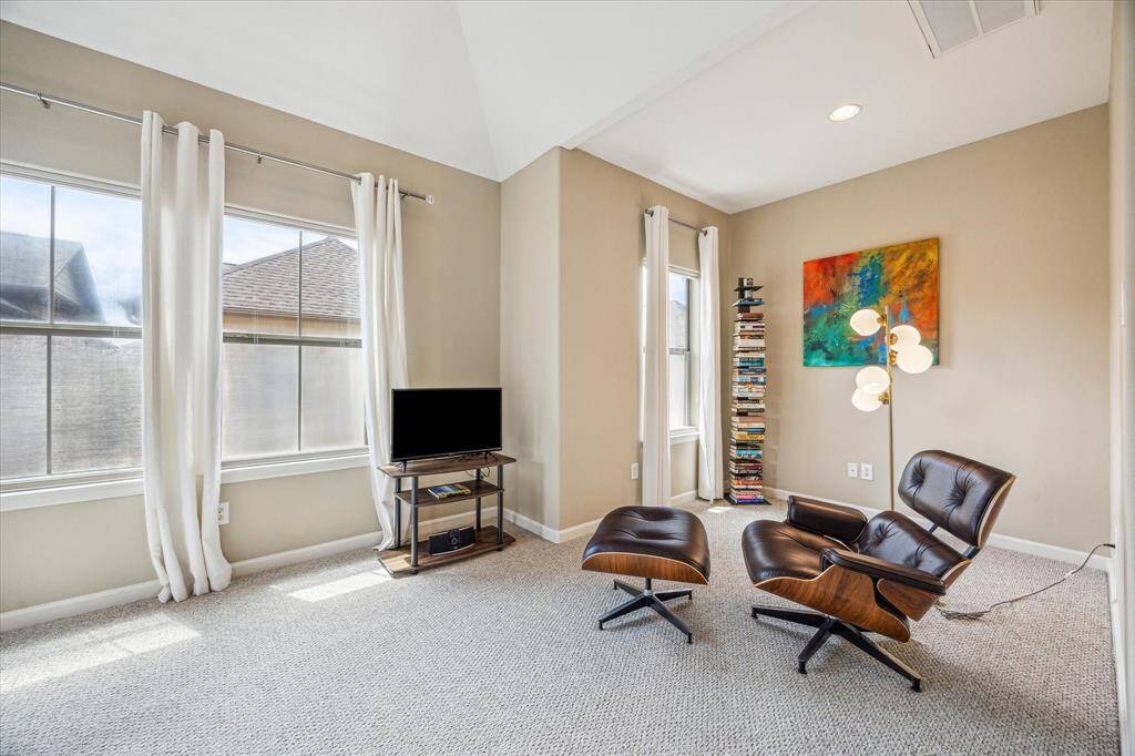 A cozy nook off the primary bedroom offers the perfect spot for reading, relaxing, or setting up a quiet lounge space.