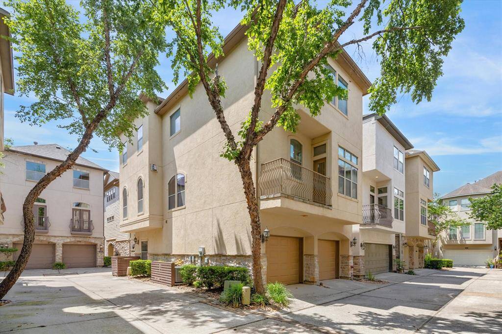 Tucked into a gated Montrose enclave, 574 Bomar sits on a desirable corner lot with charming curb appeal, arched windows, and a balcony. A shared driveway leads to the home’s rare side-by-side two-car garage, a valuable upgrade compared to the typical tandem setup, offering generous space for parking and storage. Mature trees and thoughtful landscaping add a welcoming feel to this well-positioned urban retreat.