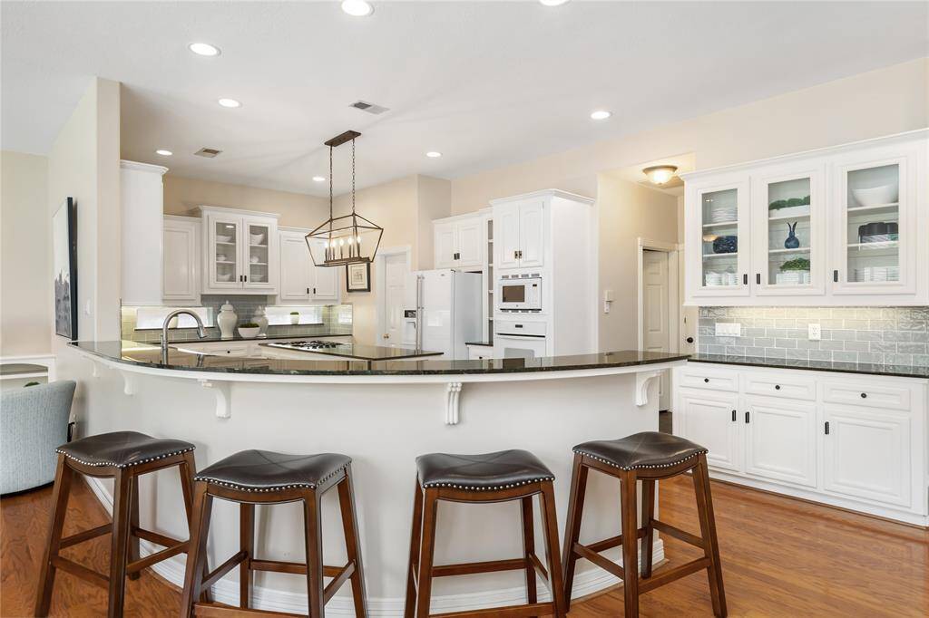 Turning our attention to the Kitchen, you'll first see the breakfast bar, which provides a casual seating option, but is also perfect for setting up snacks for parties!