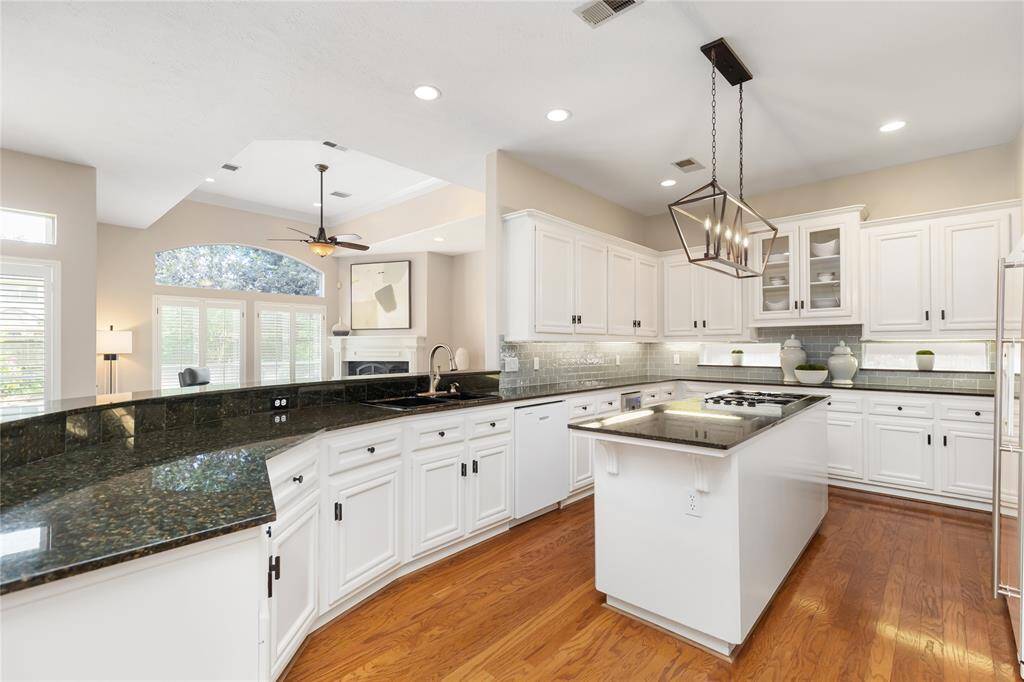 Any chef would feel at home in this Kitchen! With extensive counter and cabinet space, a convenient island, gas cooktop, and walk-in pantry, the Kitchen's design is well thought-out, as well as beautiful.