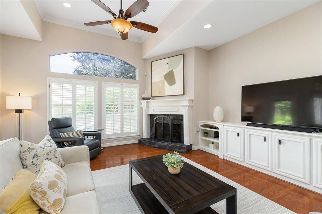 This room also offers dimmer switches for the lighting, a custom built-in which can accommodate any size television, and a wall of windows for a view of the backyard.