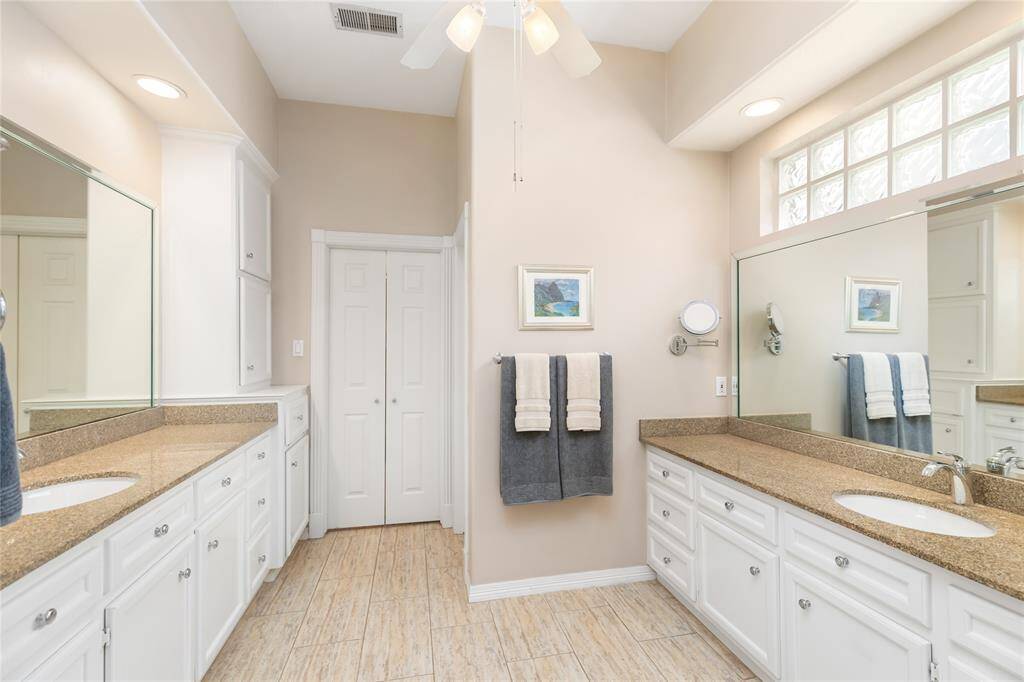 The Primary Bathroom offers tons of storage, recently replaced granite vanity counters and faucets, and lass block windows allowing for lots of natural light.