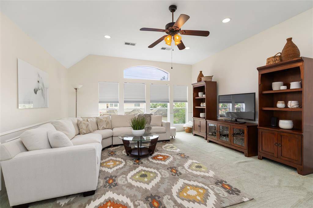 Rounding out the upstairs is the Game Room, with wainscot paneling and a wall of windows overlooking the front yard
