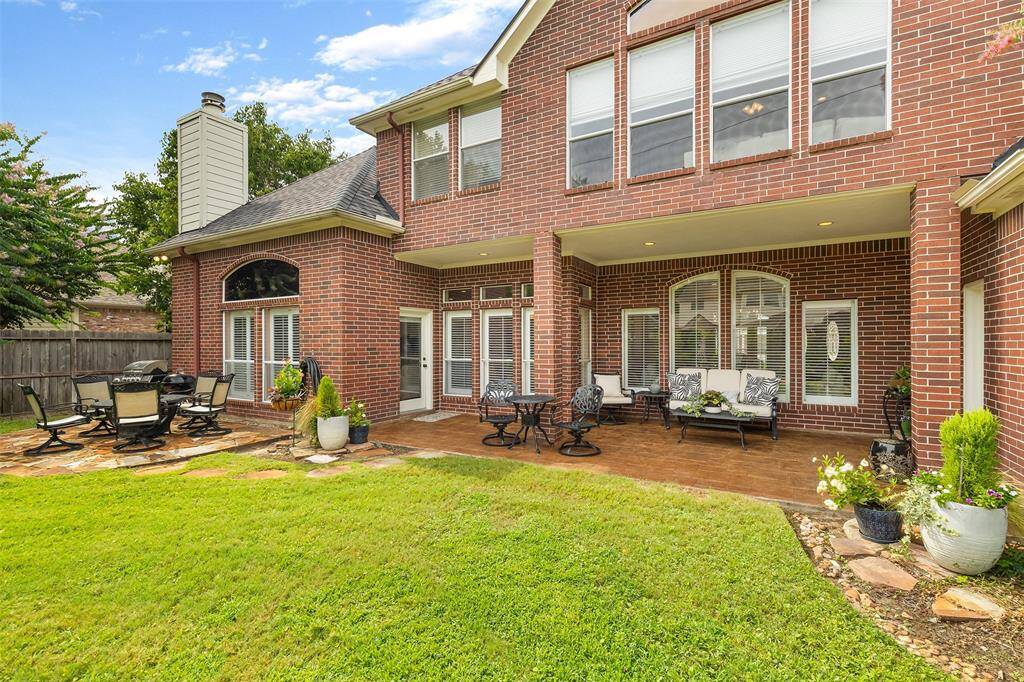 Enjoy afternoon shade from the covered stamped concrete patio.