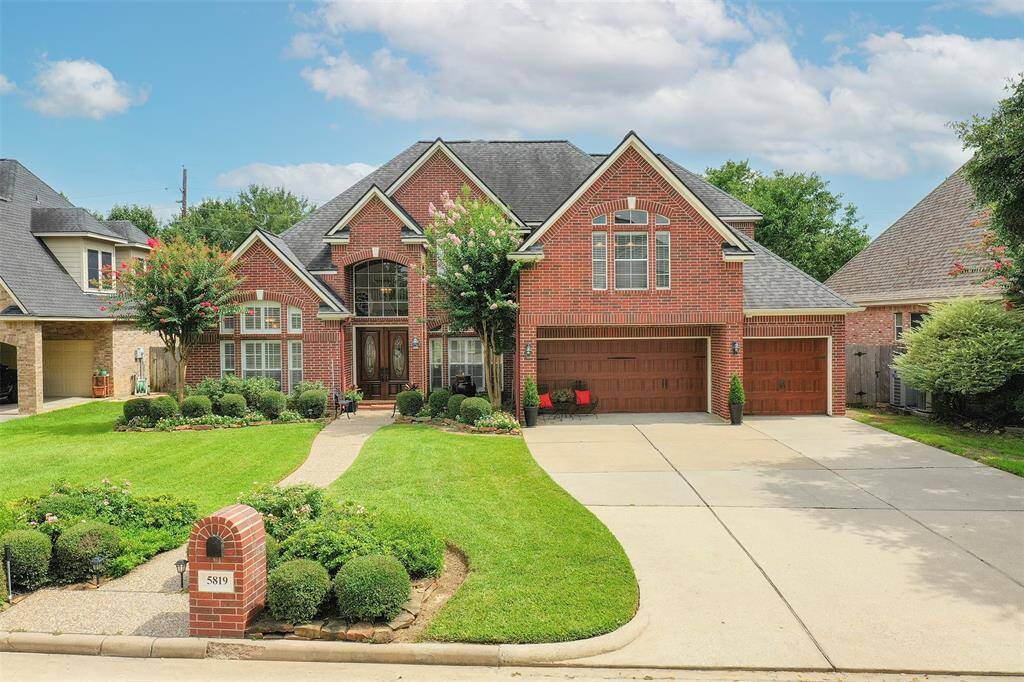 The extra wide driveway leads to a 3 car garage with upgraded wood panel doors