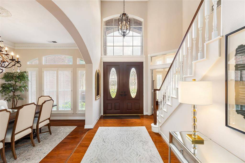 The Foyer features 20-foot triple coffered ceilings, with the Formal Dining Room pictured to the left, and the Study to the right of the front doors