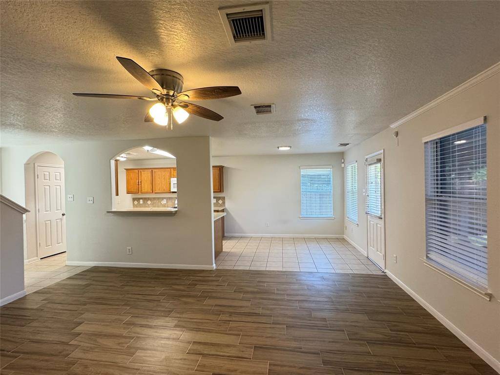 Reverse view of living room towards dining and kitchen