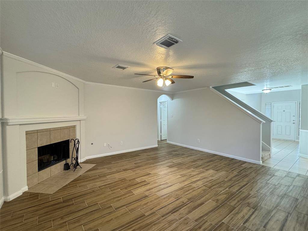 Third view of living room, powder room and primary bedroom suite beyond on left