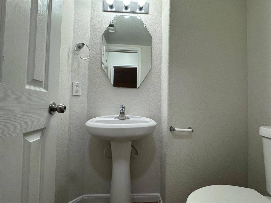 Powder room has NEW tile and toilet