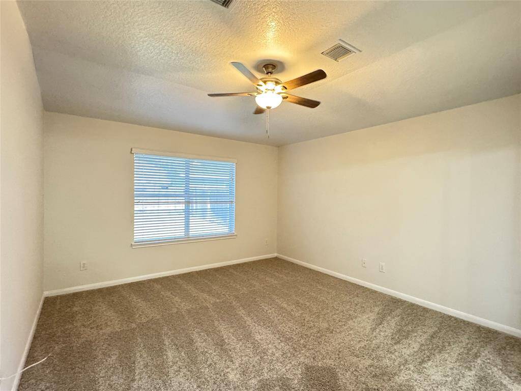 Primary bedroom with NEW carpet, NEW ceiling fan