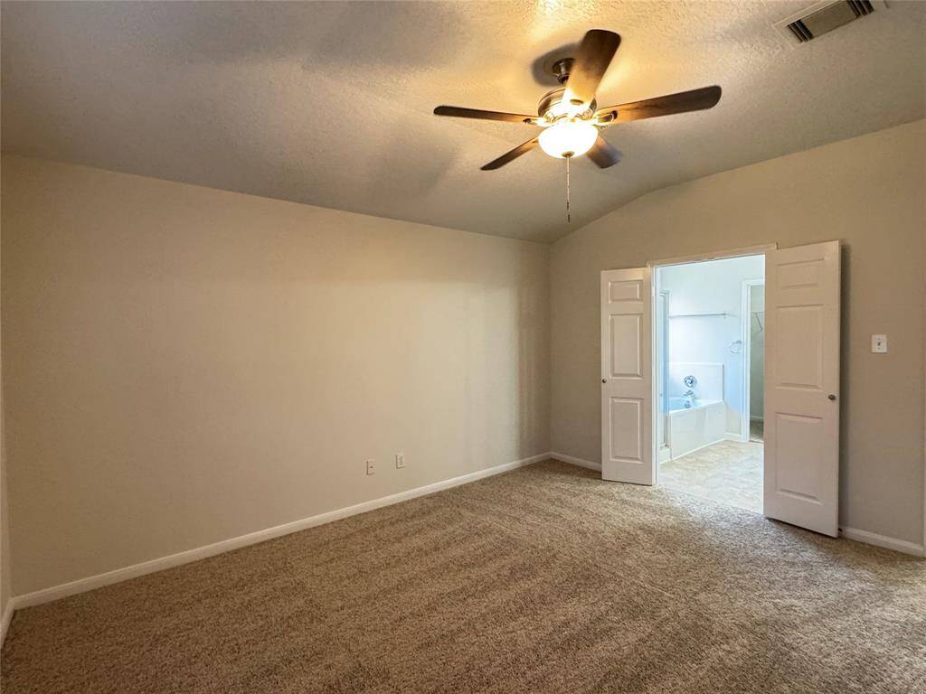 Primary bedroom looking into bathroom