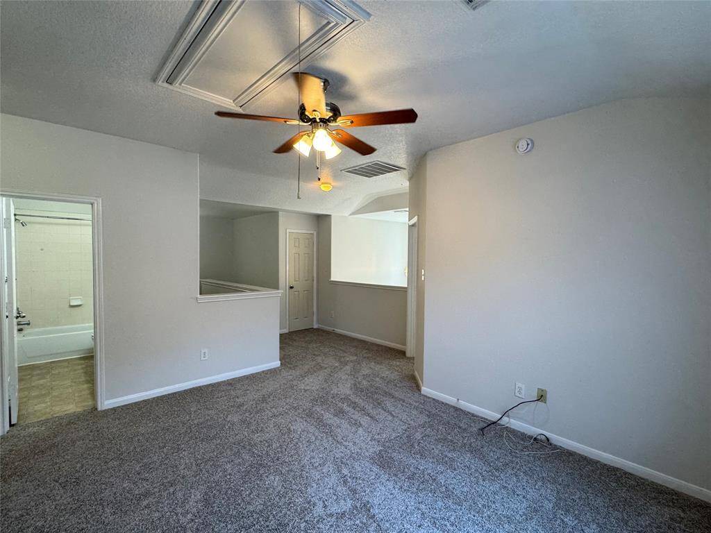 reverse view of game room with bathroom on left, storage closet on right beyond