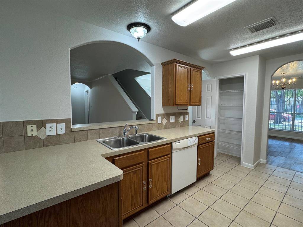 Kitchen with nice archway, tons of cabinet space, pantry on right