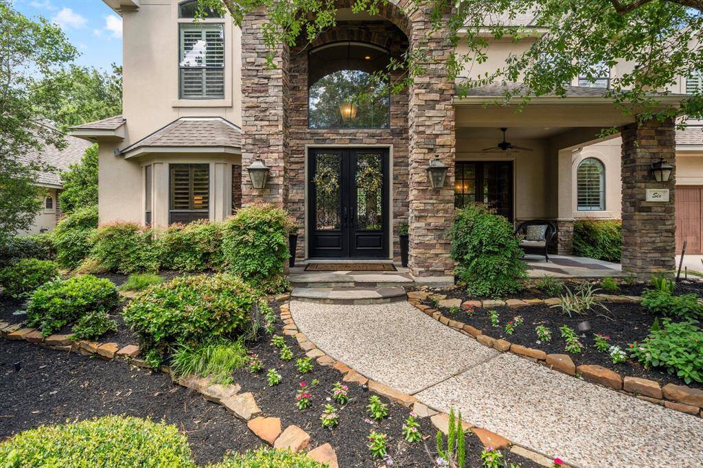Welcome to 6 Coverdell Park! This stunning home features a grand stone entrance with double doors, surrounded by lush landscaping and a welcoming porch. Perfect for buyers seeking curb appeal and sophistication.