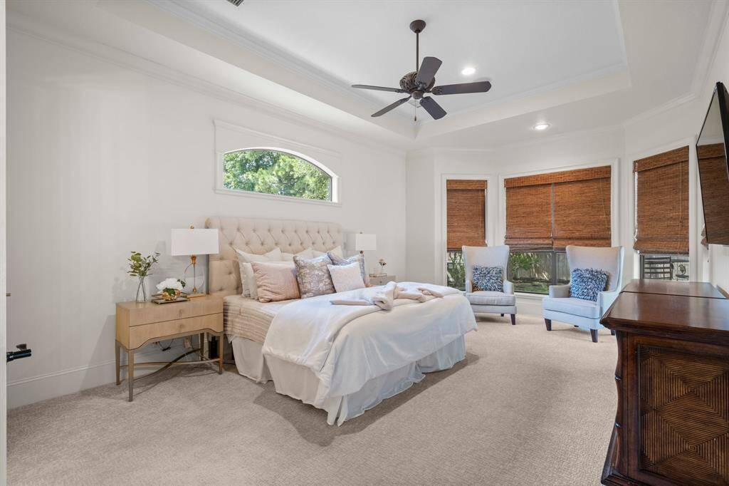 The large primary bedroom features a sitting area and recent carpet.