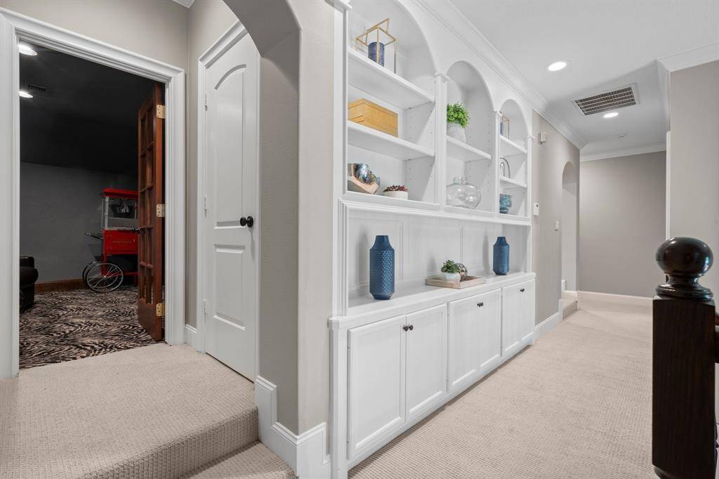Upstairs hallway leading to 4 bedrooms, media room and game room.