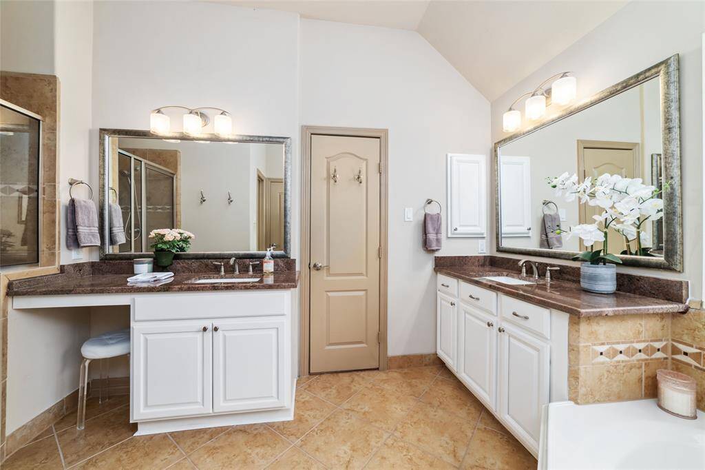 Elegant primary bathroom featuring spacious dual vanities for added convenience.