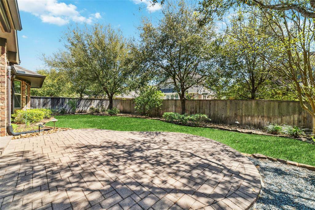Expansive brick patio perfect for sunbathing, bird watching, and outdoor dining.