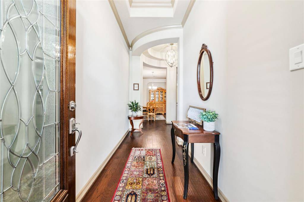 Step into the inviting foyer with a stunning view of the formal dining room.