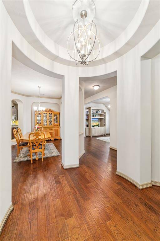 Welcome home to elegance with stunning tray ceilings and rich hardwood floors greeting you at the entrance.