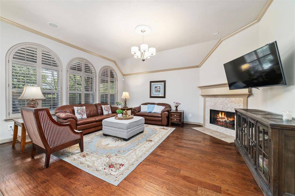 Cozy family room featuring a gas log fireplace with serene views of the covered porch and backyard.