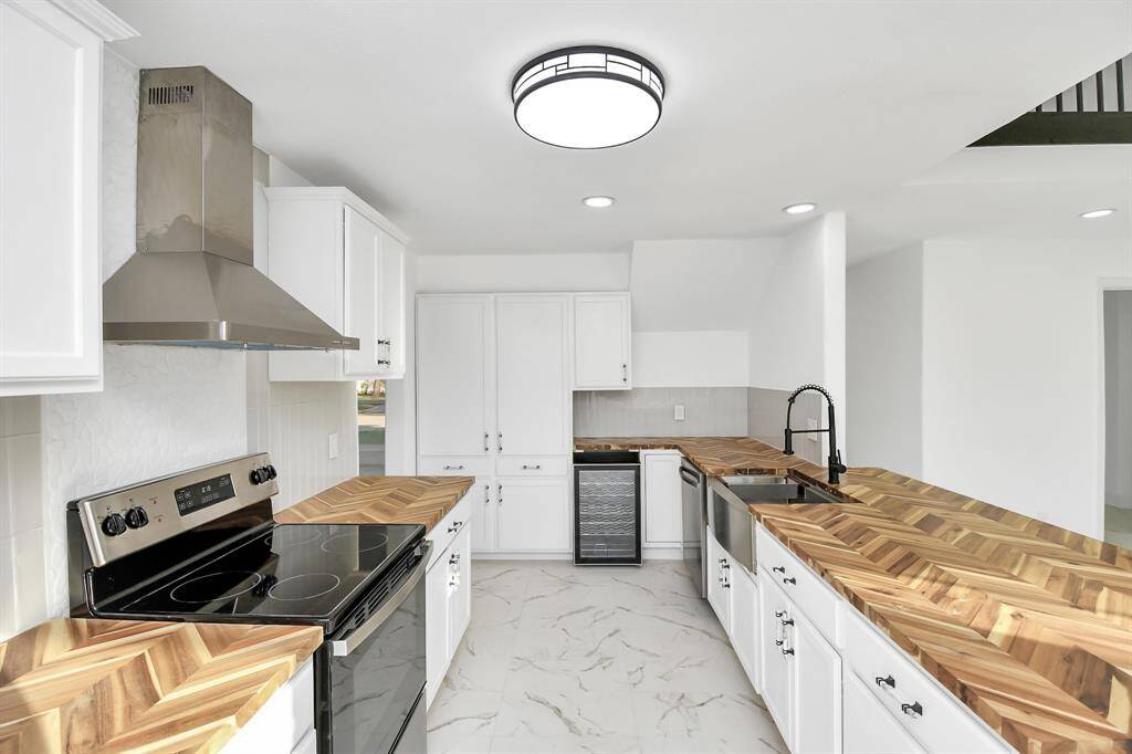 A tucked-away wine fridge, conveniently located near the dining room, adds a touch of luxury and practicality to the already impressive gourmet kitchen.