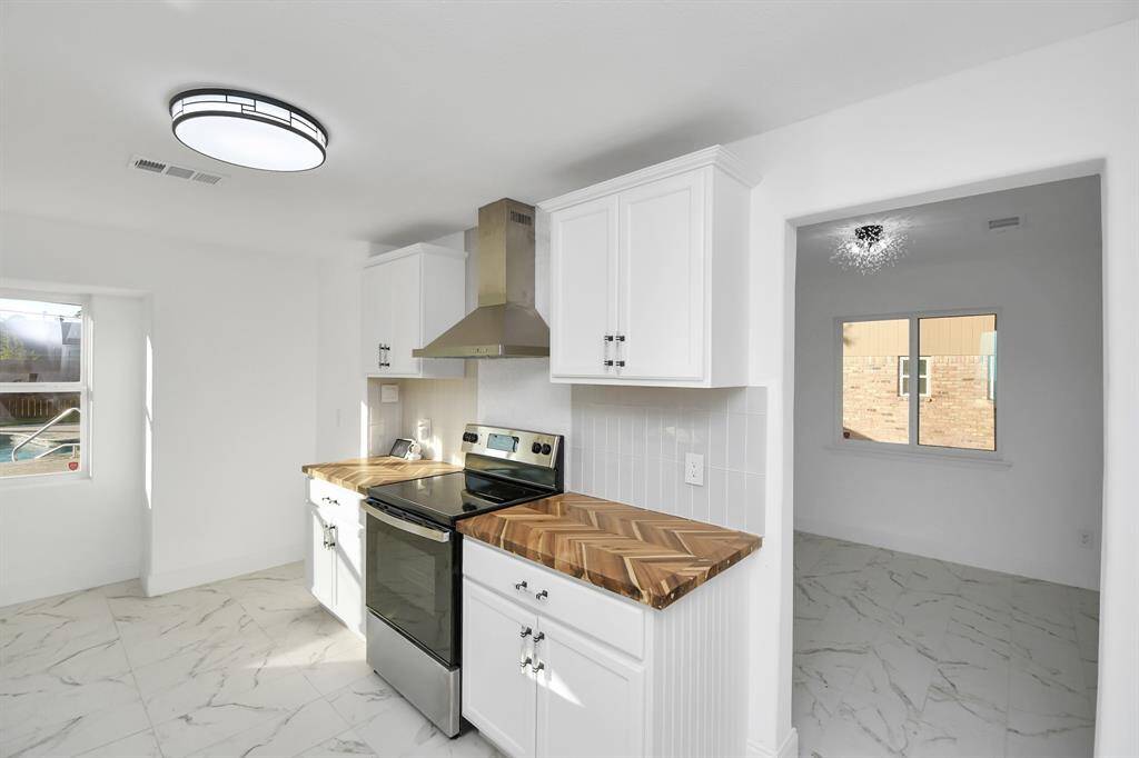The dining room is conveniently located next to the kitchen, making entertaining effortless