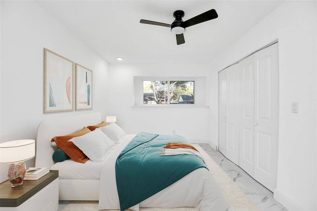 This room is generously sized, featuring the same marble subway tiles and crisp white walls, providing the perfect canvas for your design ideas. (Virtually Staged)