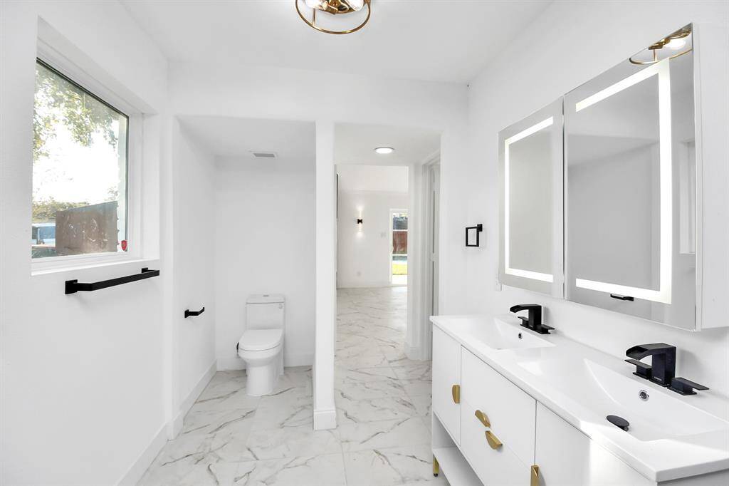 Dual sinks and black hardware round out this bathroom.