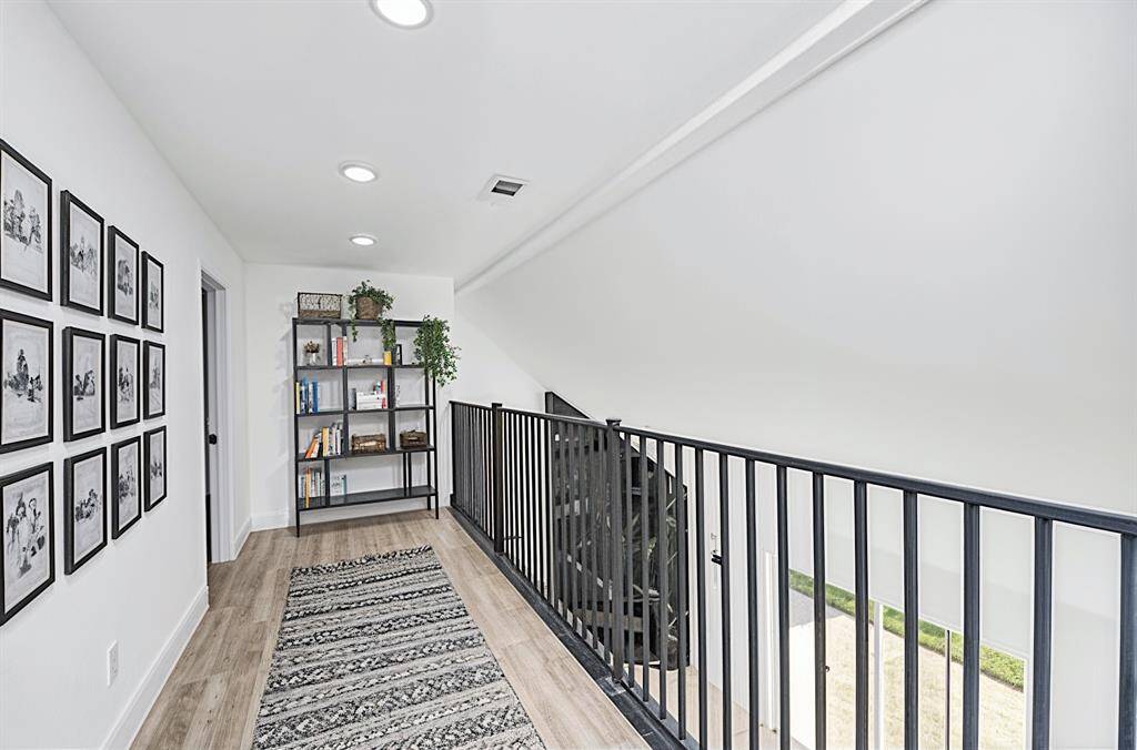The upstairs features engineered wood floors that are both low-maintenance and durable, adding a warm touch. (Virtually Staged)