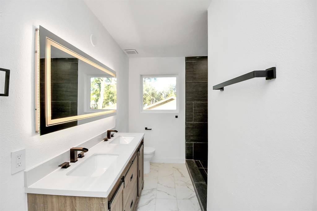Around the corner you will find a sleek walk-in shower.