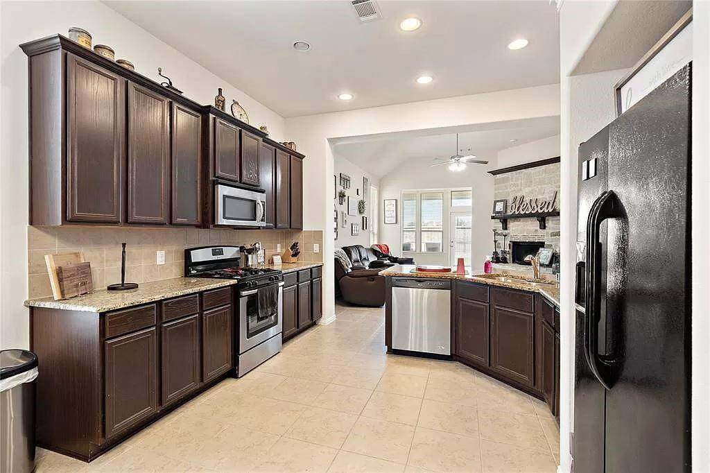 Kitchen is conveniently located near living room and comes equipt with appliances, granite counter tops and ample cabinet space.