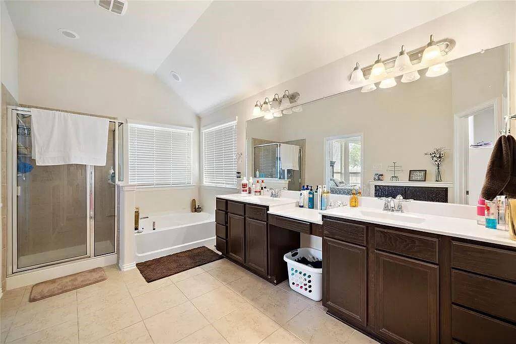 Double vanity primary bathroom includes Shower and soaking tub.  Perfect amount of lighting, storage, and counter space.