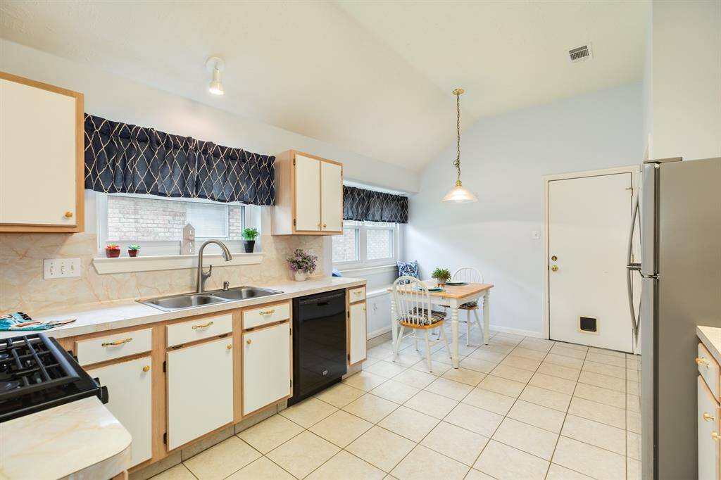Kitchen offers plenty of cabinet & counter space, a breakfast nook with bench seating, and large pantry.