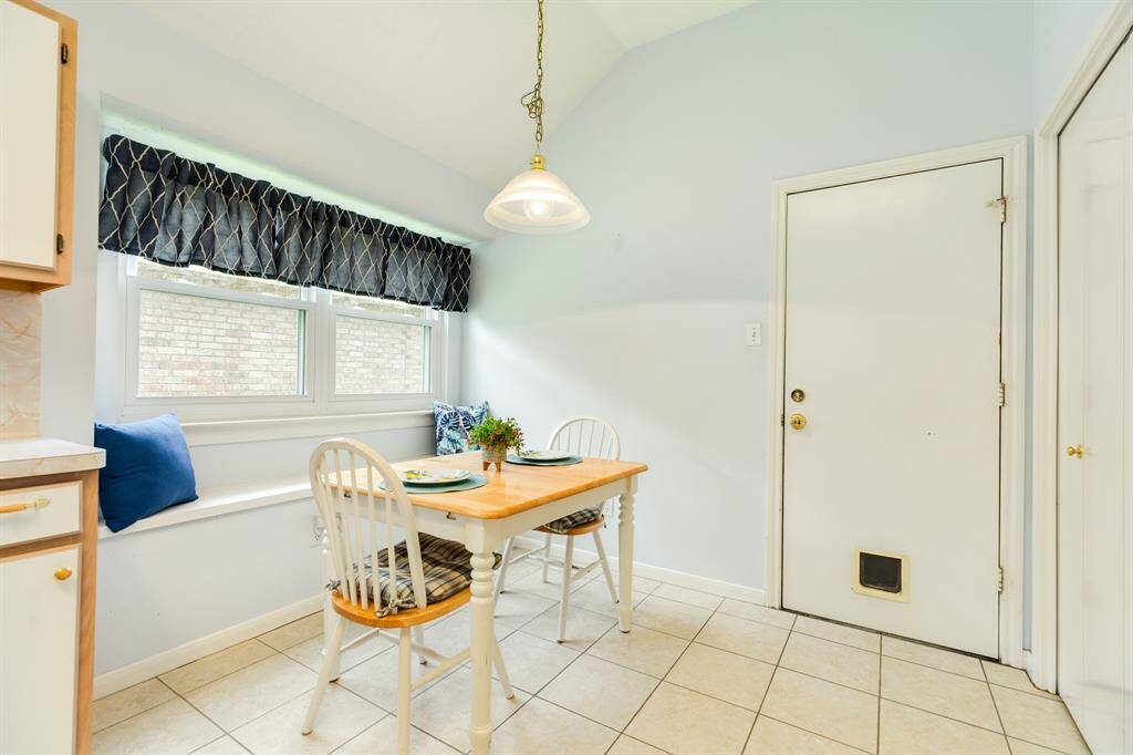 Kitchen offers plenty of cabinet & counter space, a breakfast nook with bench seating, and large pantry.