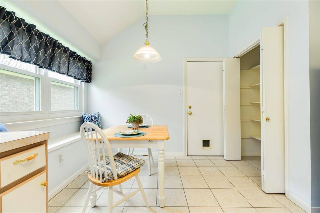Kitchen offers plenty of cabinet & counter space, a breakfast nook with bench seating, and large pantry.