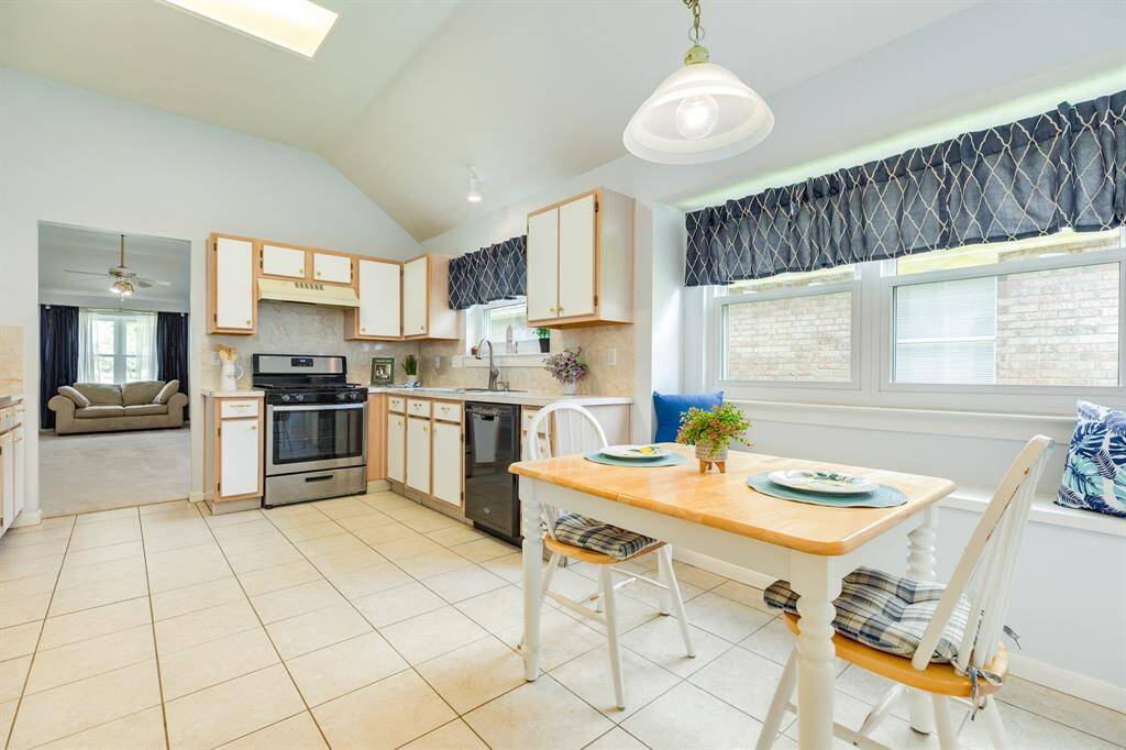 Kitchen offers plenty of cabinet & counter space, a breakfast nook with bench seating, and large pantry.