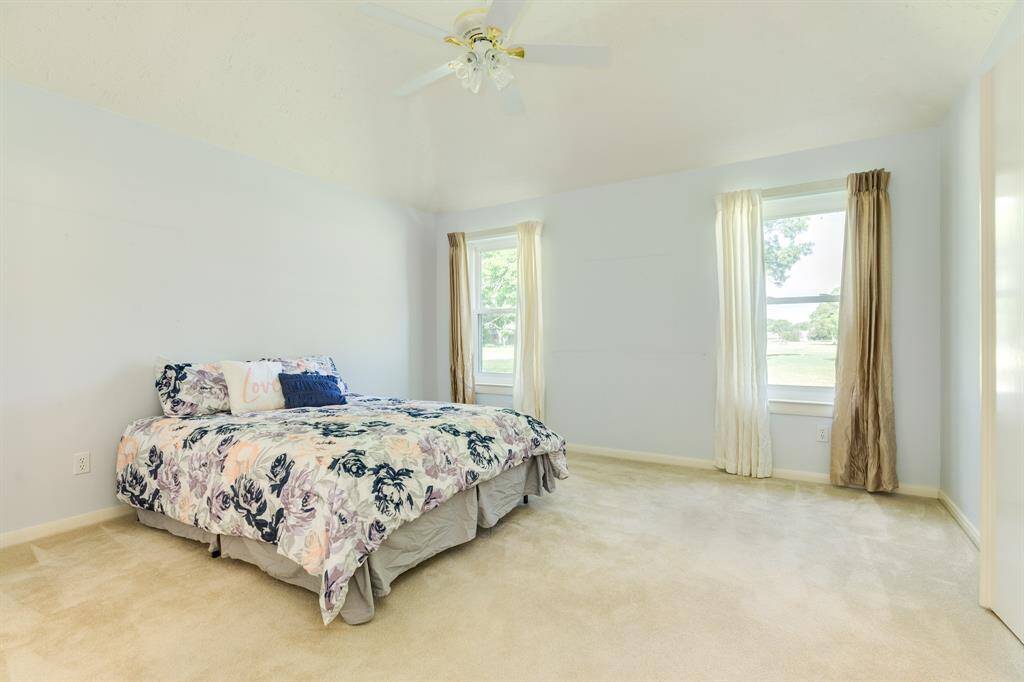 Primary bedroom with golf course view has an ensuite bath with a large walk-in closet, dual sinks, jacuzzi tub, walk-in shower.