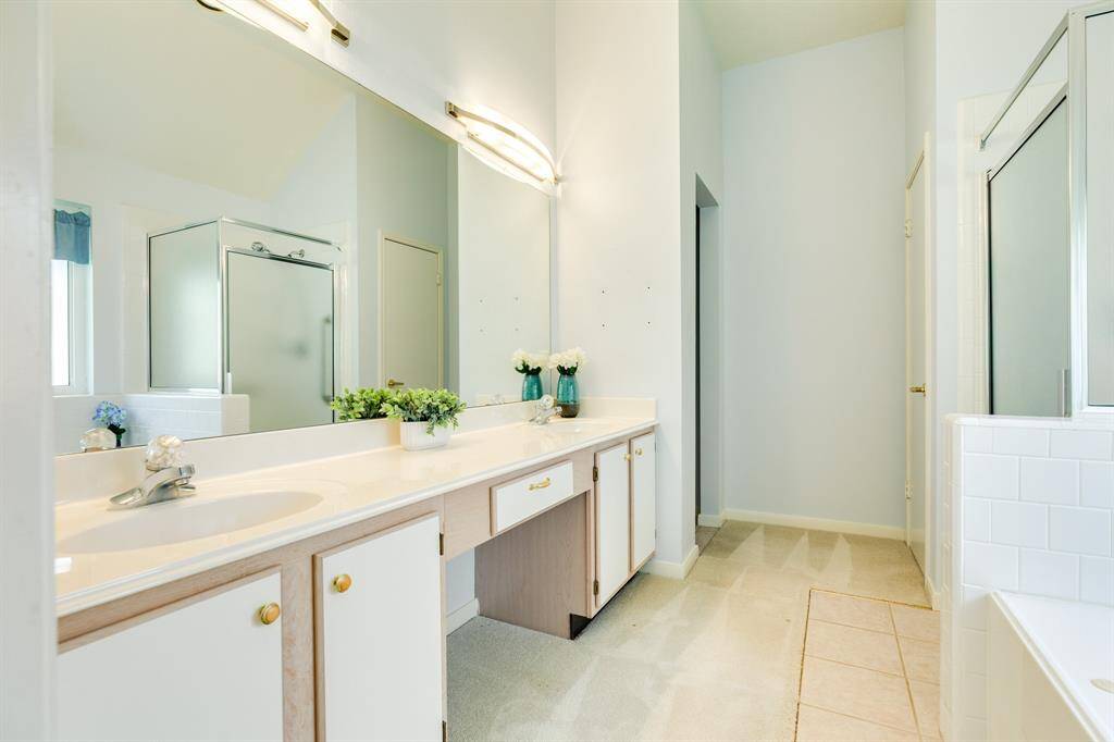 Primary ensuite bath with a large walk-in closet, dual sinks, jacuzzi tub, walk-in shower.