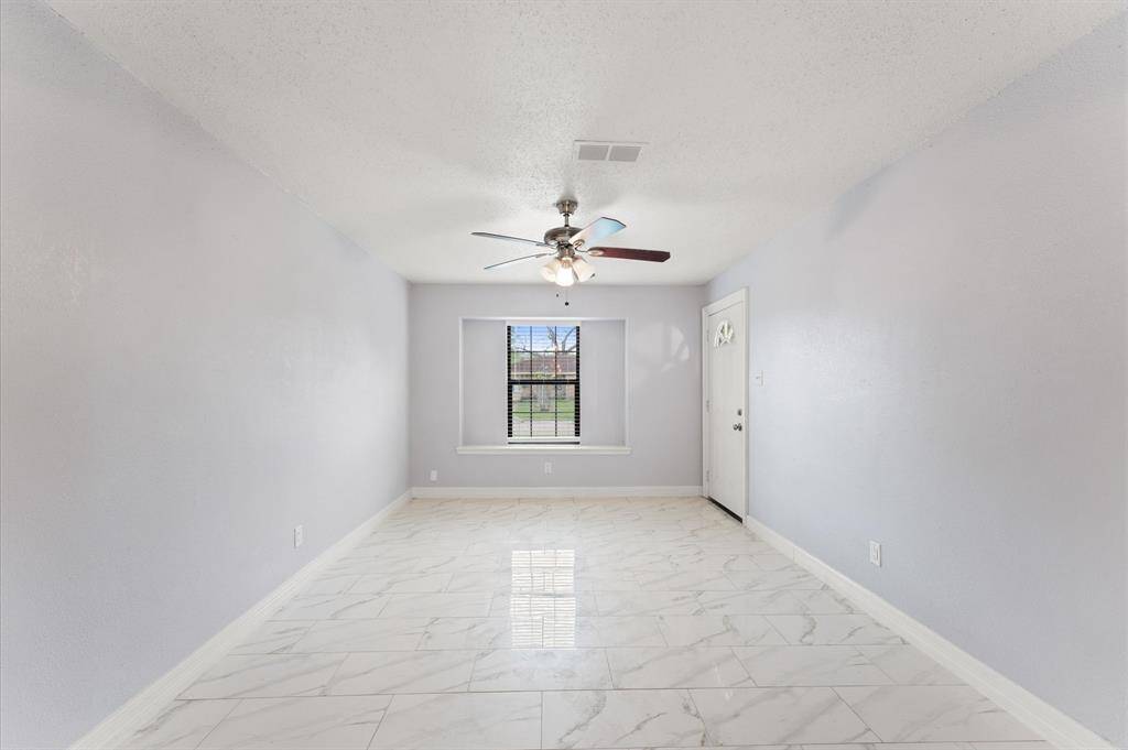 Living room with updated flooring and fresh paint.