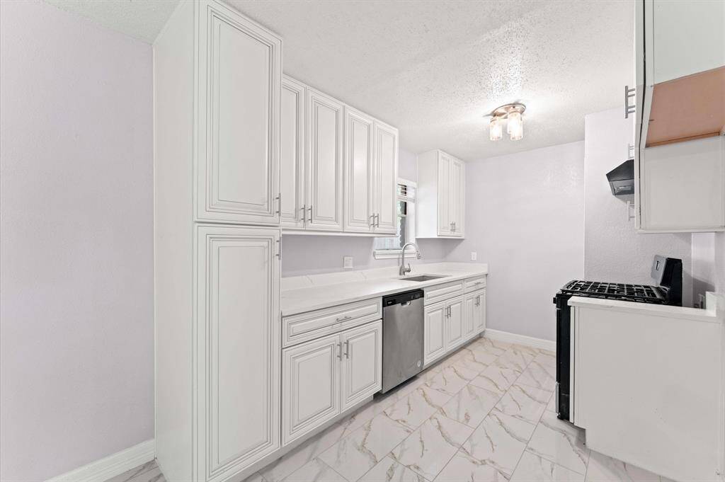 Updated kitchen with new cabinets, new flooring and stainless steel appliances