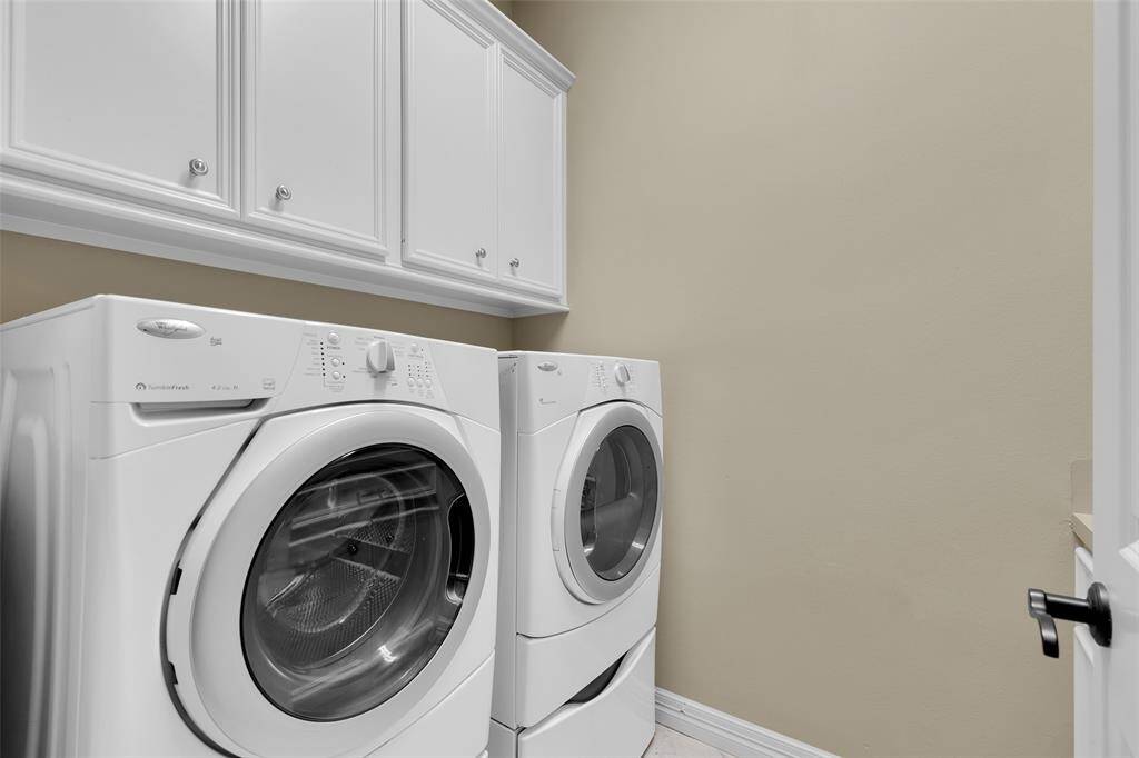 Large, first floor utility room with an abundance of built in cabinetry