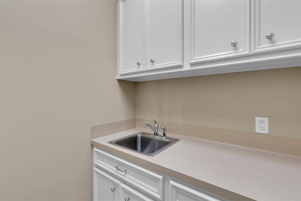 Another photo of utility room. Plenty of storage and extra sink for hand washing located on first floor.