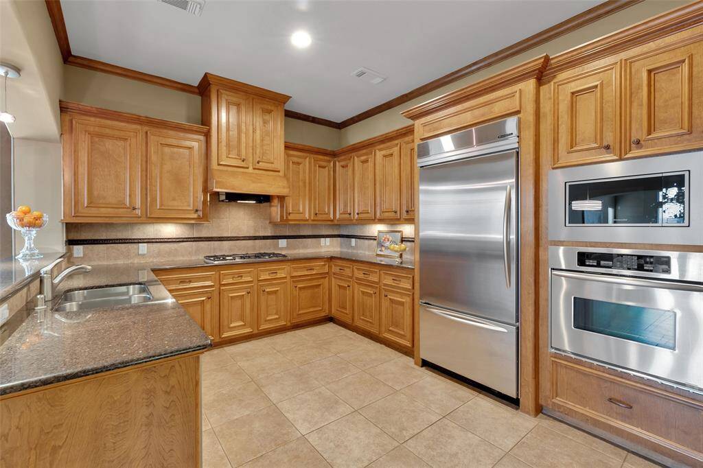 Spacious chef's kitchen with granite counter tops, professional grade appliances and high end hardwood custom cabinetry