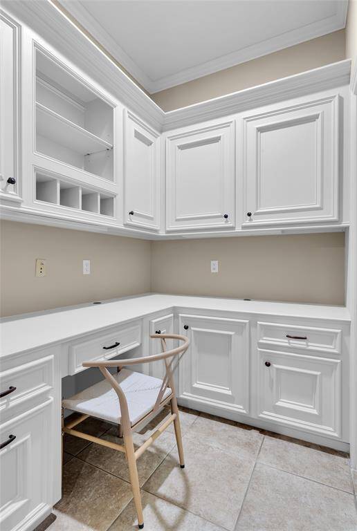 A custom-built desk area  off  kitchen. Bountiful storage space easily accommodates filing, schoolwork, and other needs.