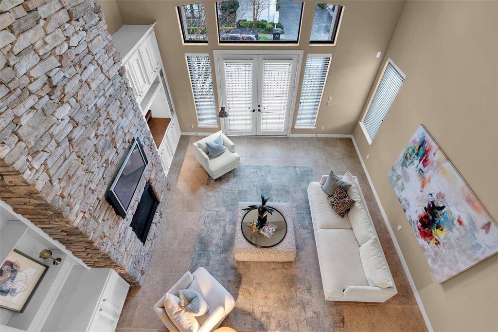 View of living room from third floor. Stone fireplace is magnificent