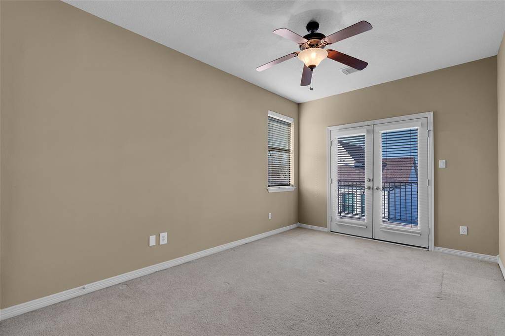 One of two secondary bedrooms on third floor. Both bedrooms have access to balcony in back.