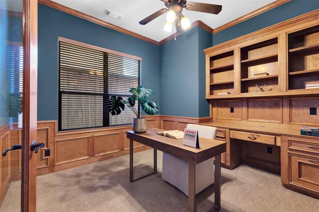 The perfect home office with built in shelving and desk. Glass french doors allow for privacy and light.