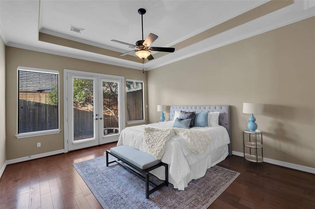 First floor primary suite is a retreat unto itself. French doors lead to a peaceful courtyard
